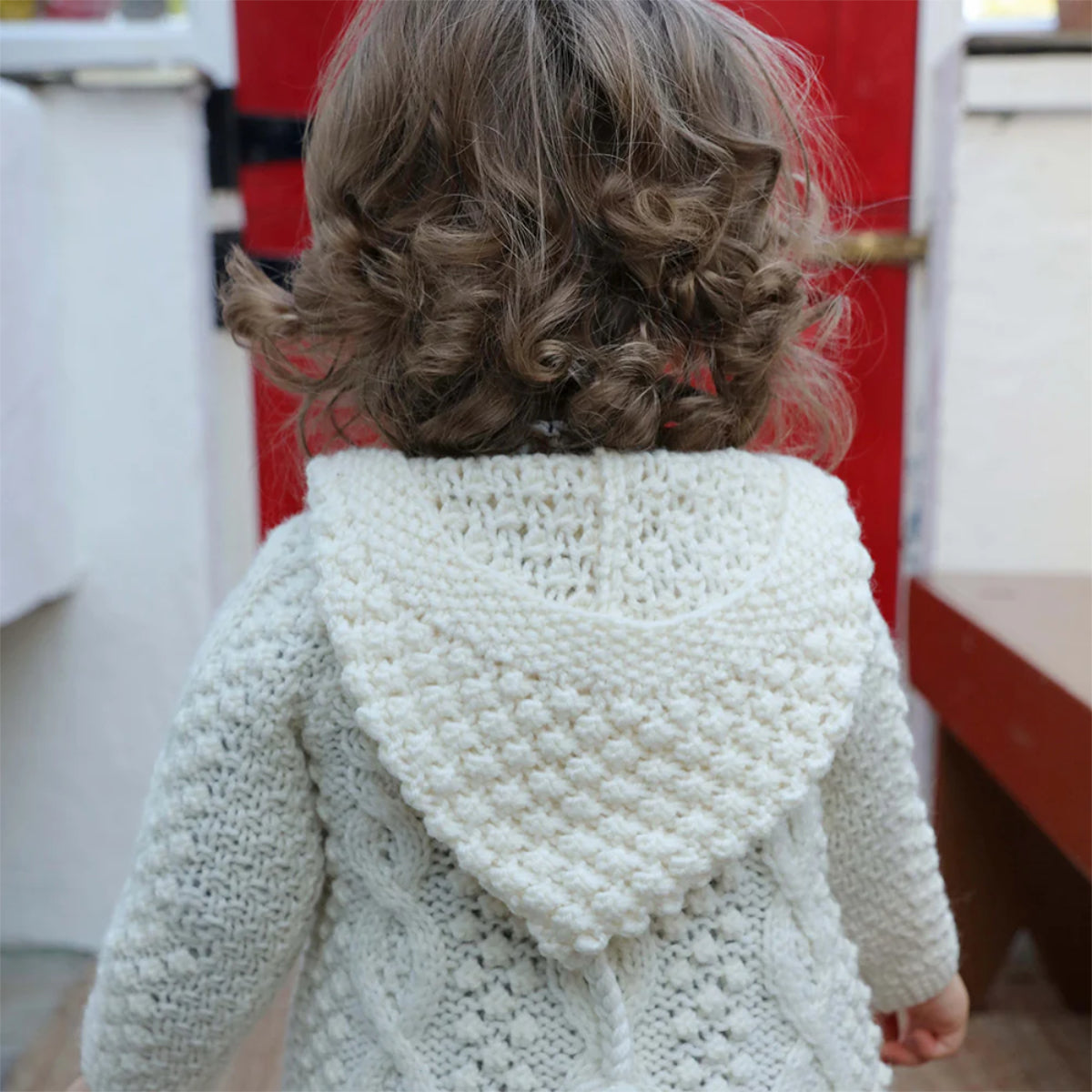 Maglioncino Aran Baby con cappuccio in Lana Irlandese lavorata a mano