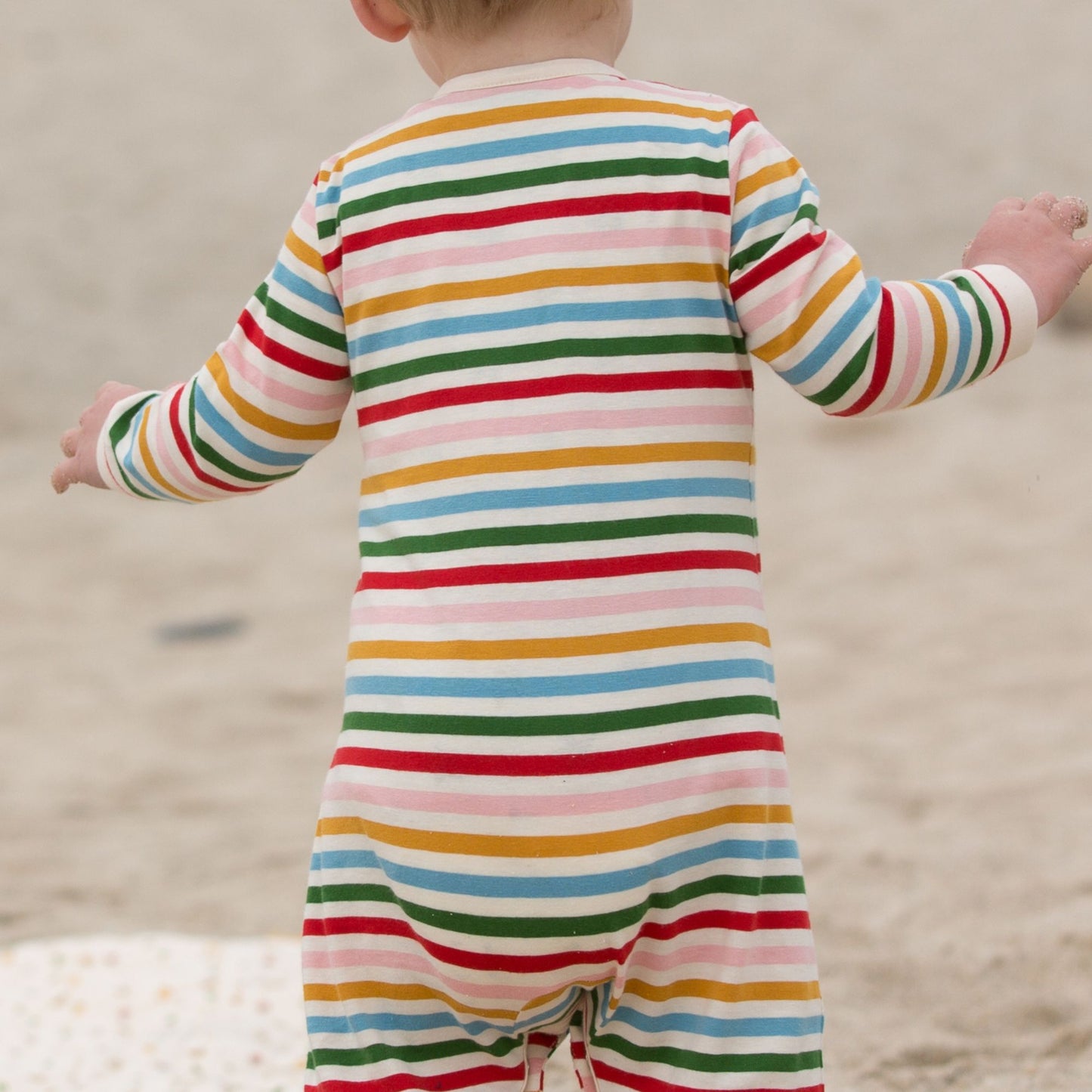 Tutina neonato con piedini in cotone biologico a righe arcobaleno